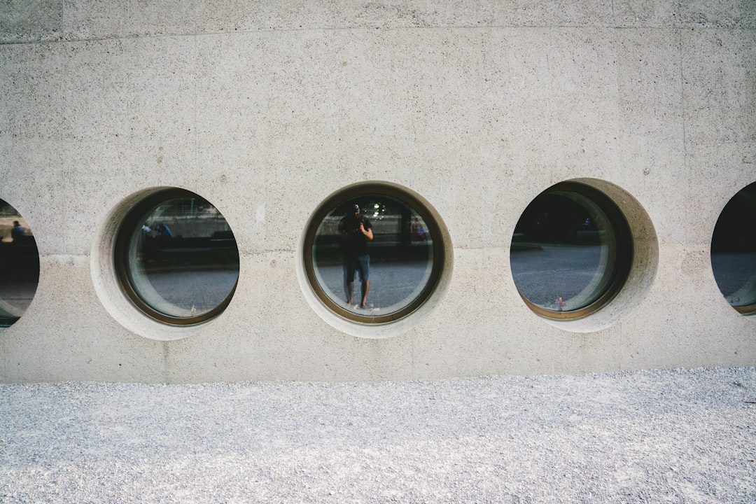 black round framed mirror on gray wall