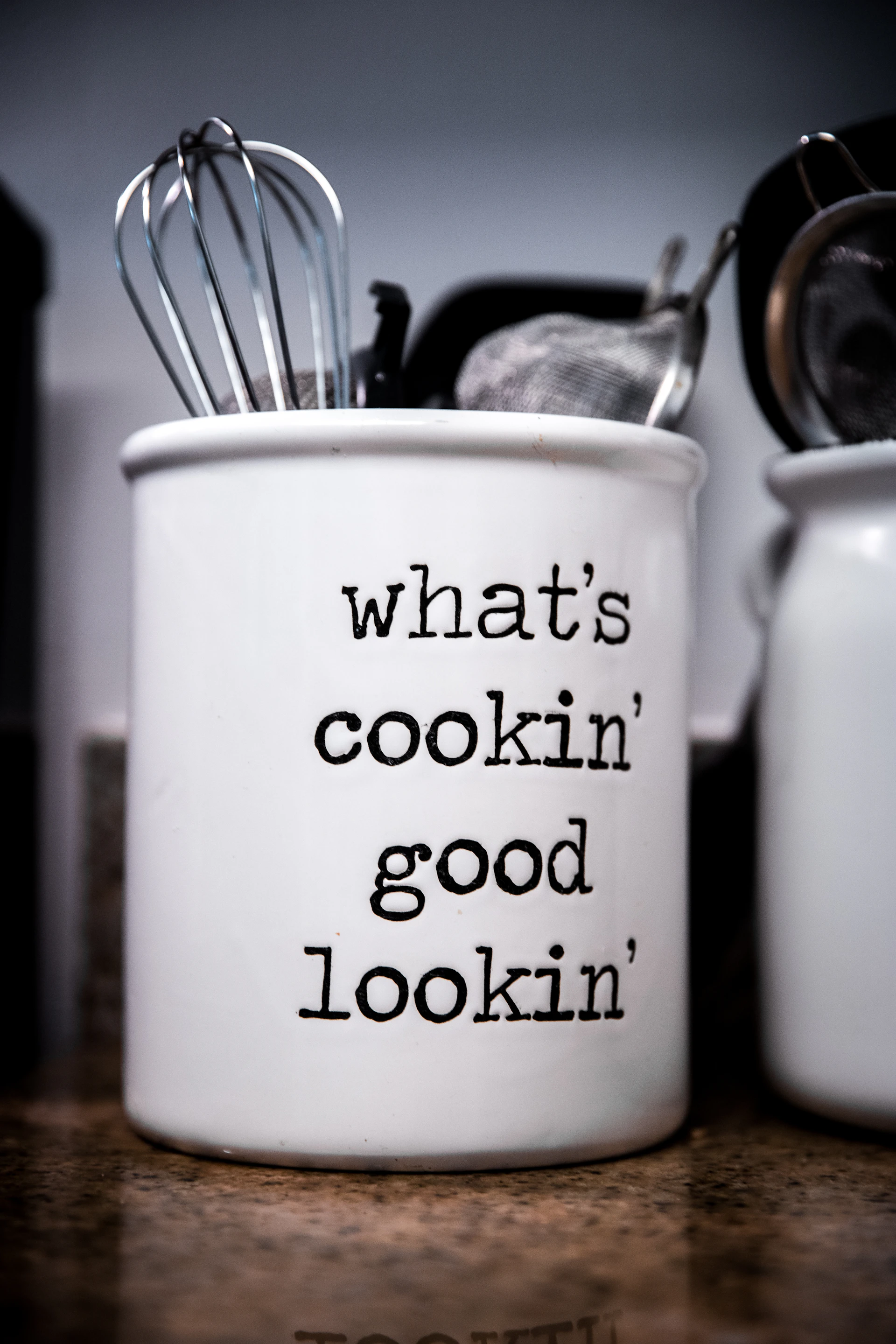 white ceramic mug with stainless steel spoon and fork