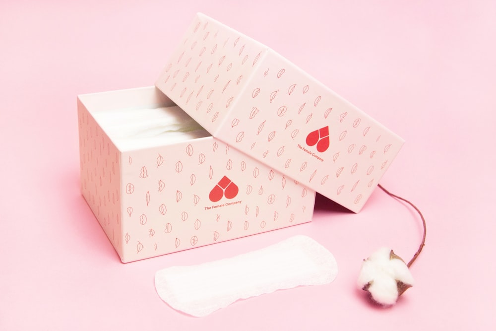white bear plush toy on white and pink heart print gift box