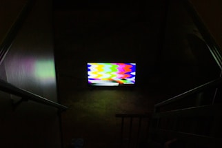 black flat screen tv turned on displaying soccer game
