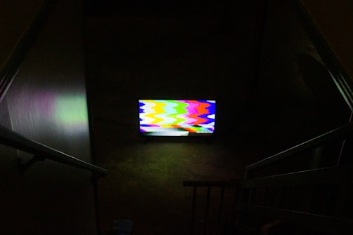 black flat screen tv turned on displaying soccer game