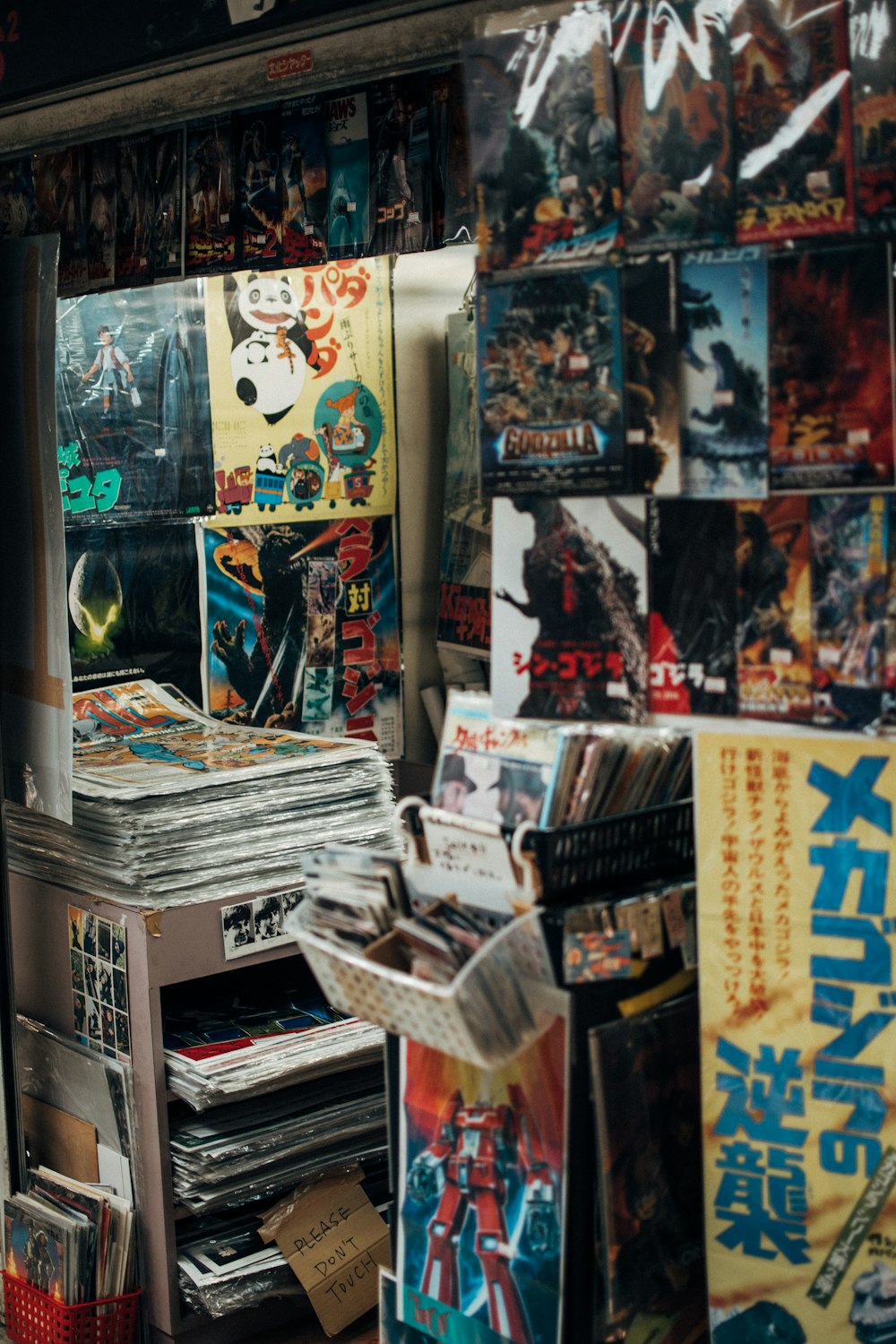 assorted magazines on white wooden shelf