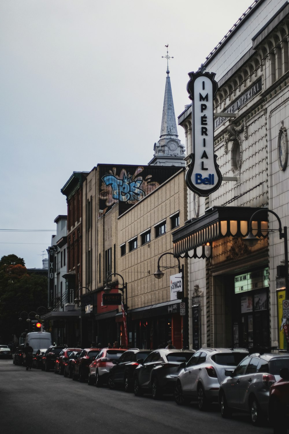 cars parked beside brown concrete building during daytime