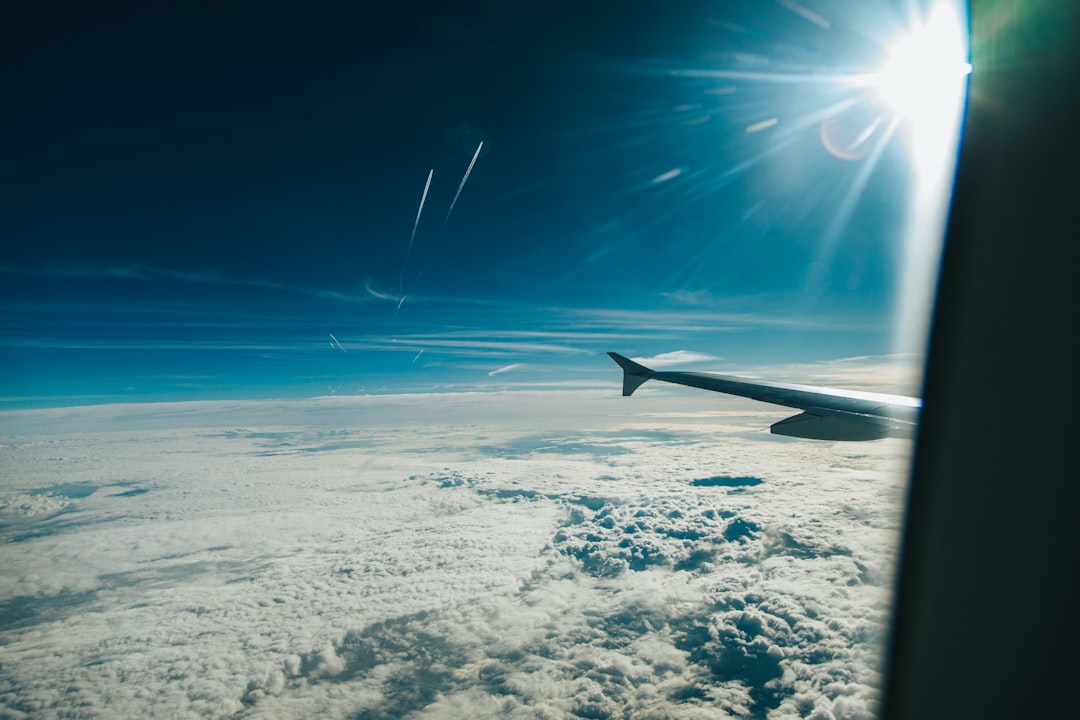 airplane wing above white clouds during daytime