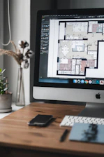 silver imac on brown wooden table