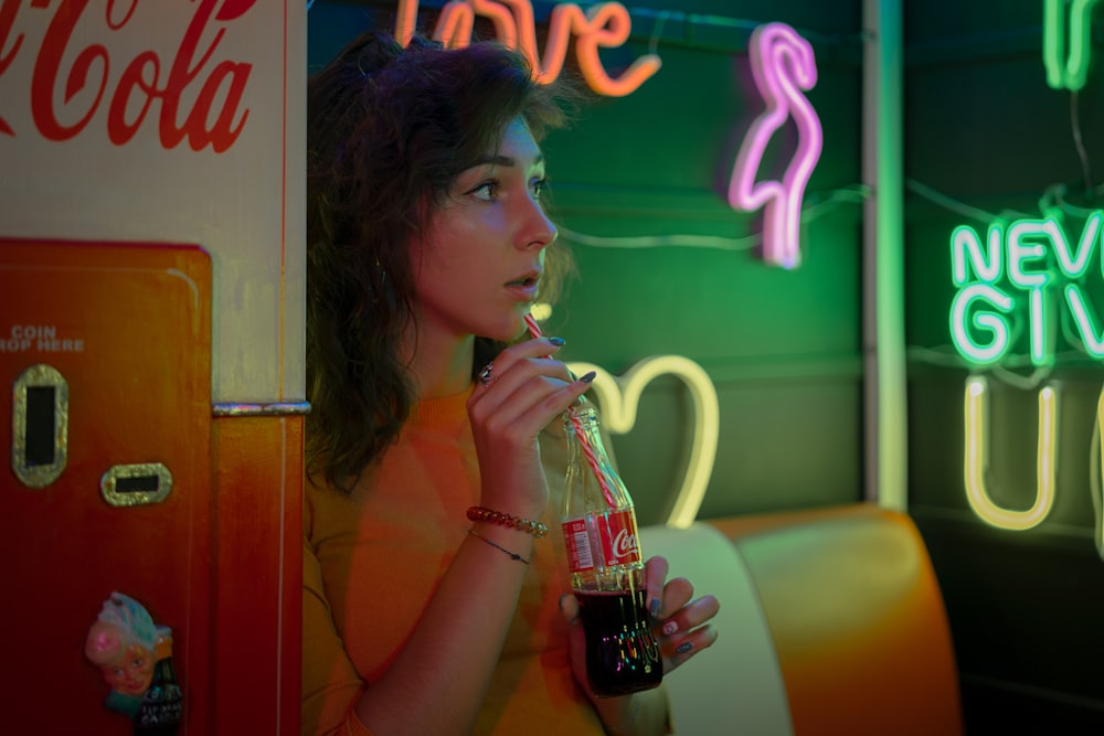 woman drinking coca cola bottle