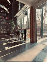 A warm café corner where a reader is immersed in a graphic novel, sunlight streaming in.