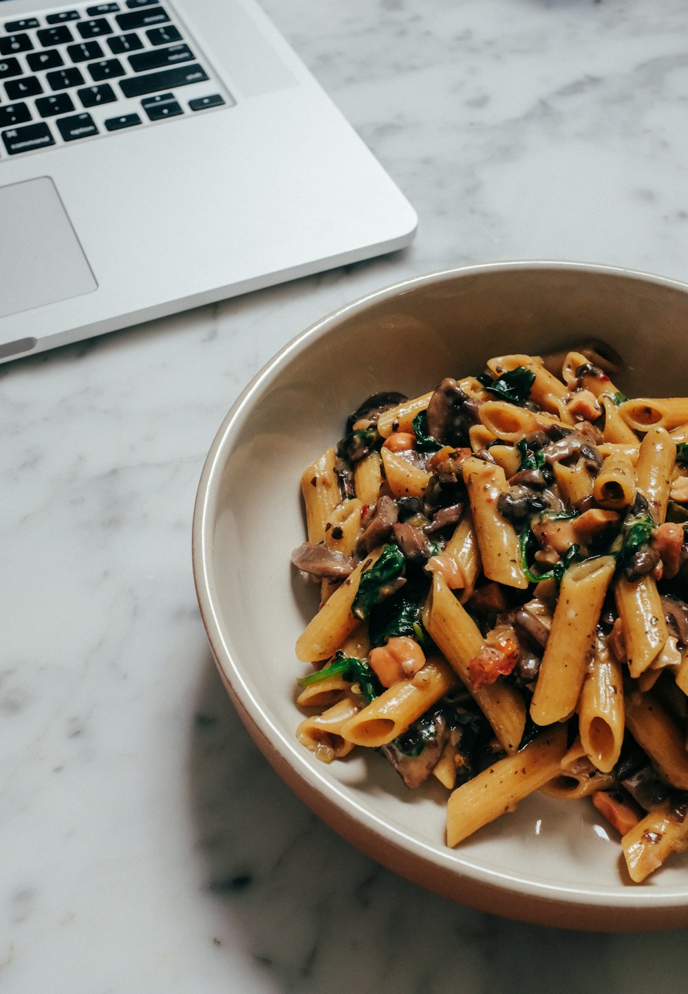 brown and green food in white ceramic bowl