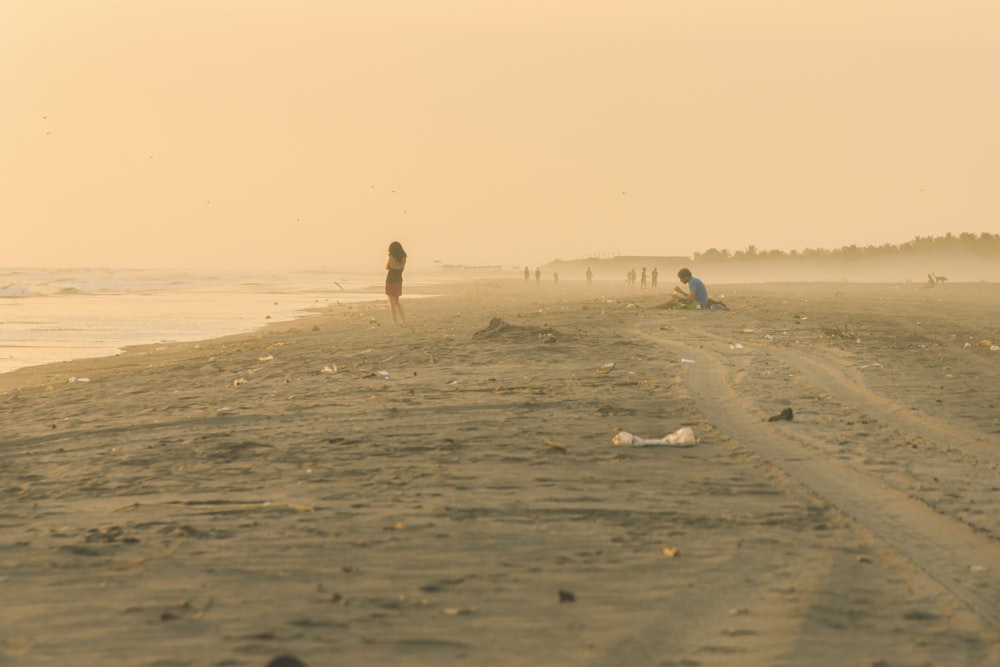 man in black shorts walking on brown sand during daytime