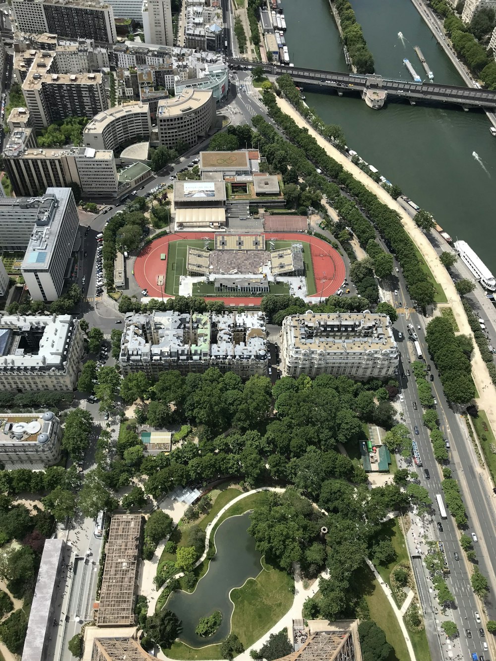 aerial view of city buildings and green trees during daytime