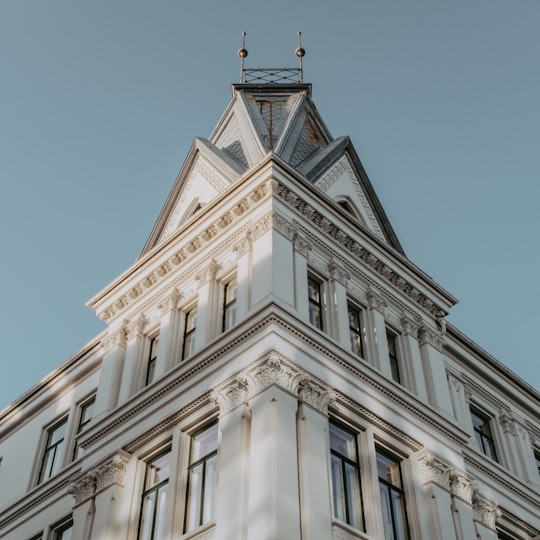 white concrete building under blue sky during daytime in Oslo Norway