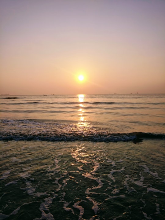 ocean waves crashing on shore during sunset in Kakinada India