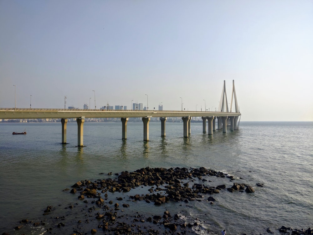 white bridge over the sea during daytime