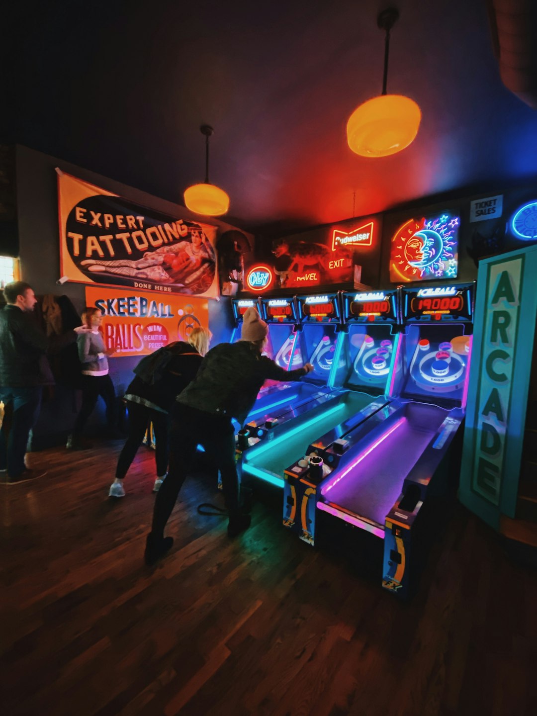 people playing arcade game inside room