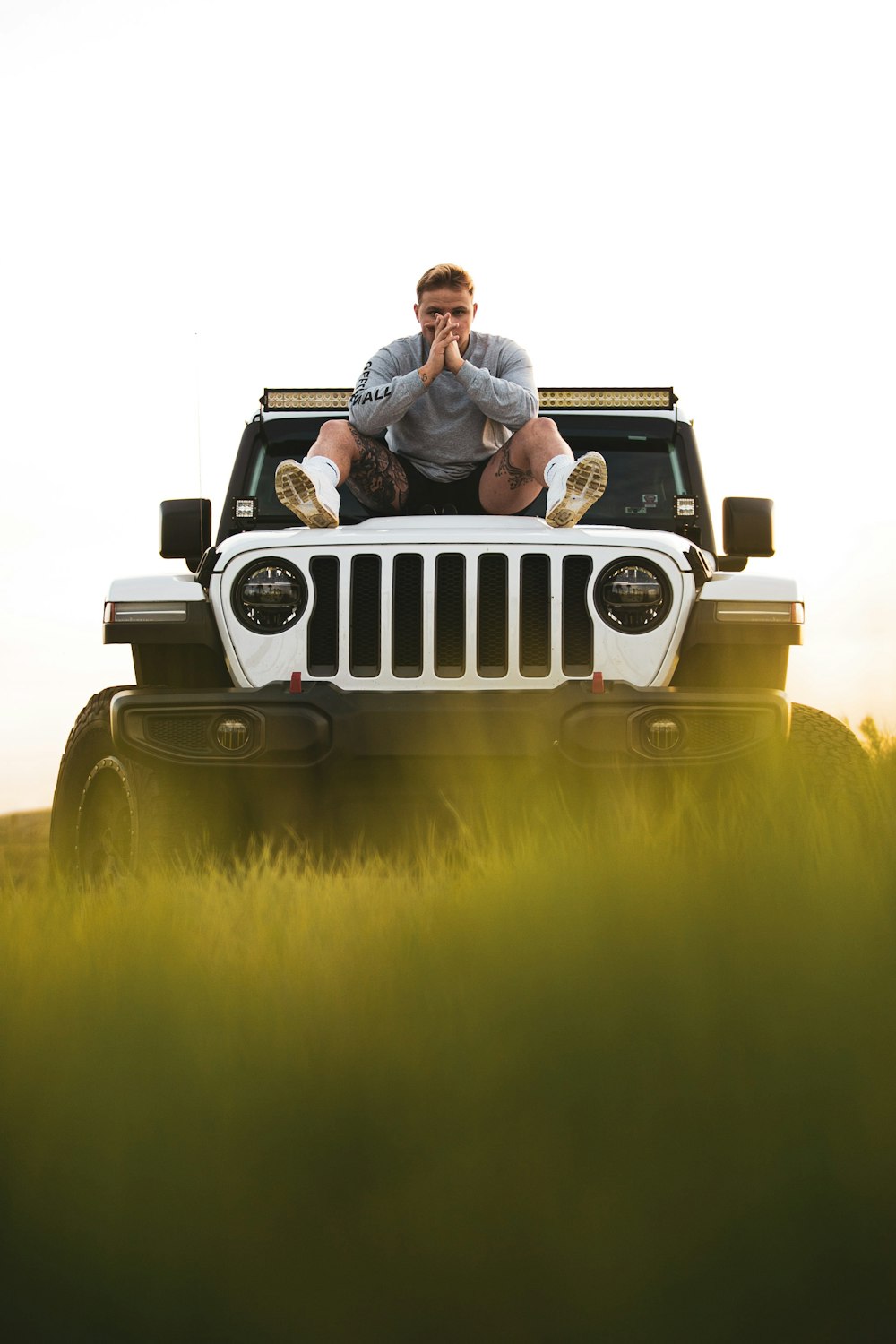 2 men in white jeep wrangler