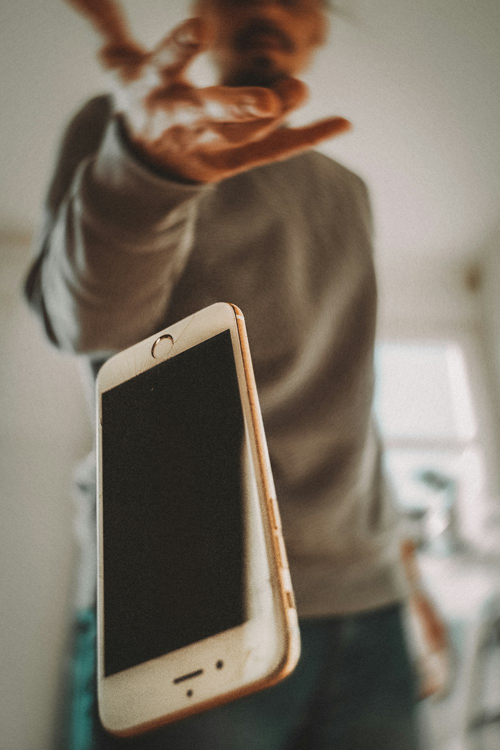 person holding white ipad mini