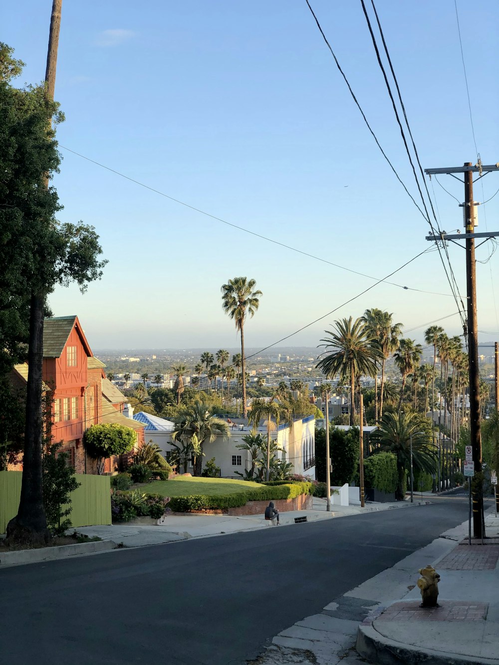 white and brown houses near green trees under blue sky during daytime