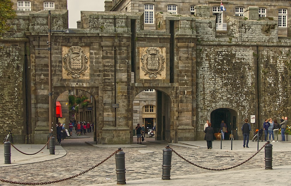 people walking on sidewalk near building during daytime