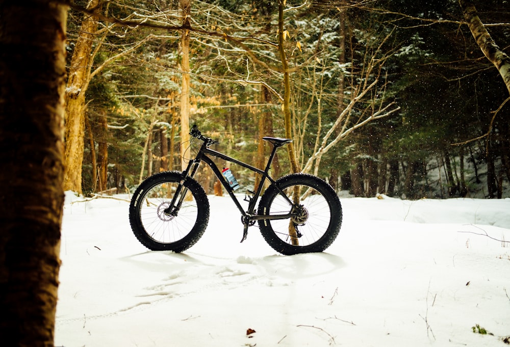 black and gray hardtail mountain bike on snow covered ground