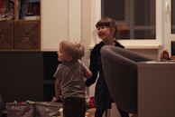 A child playing with a caregiver in a bright, cheerful environment.