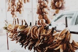 A variety of colorful fresh fruits including bananas and onions on display.