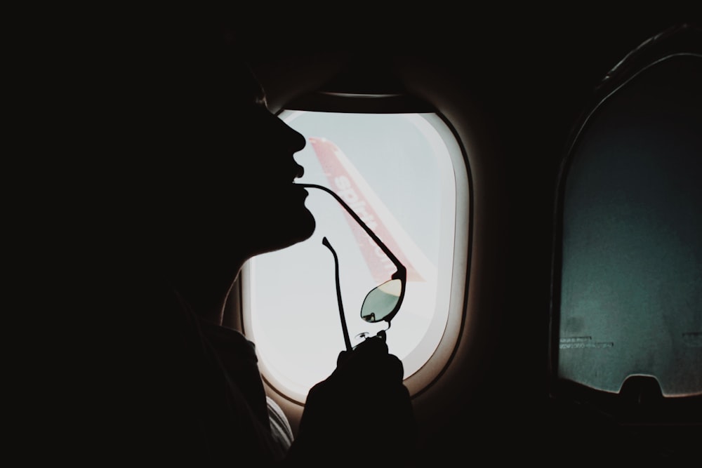 person in car looking at the window