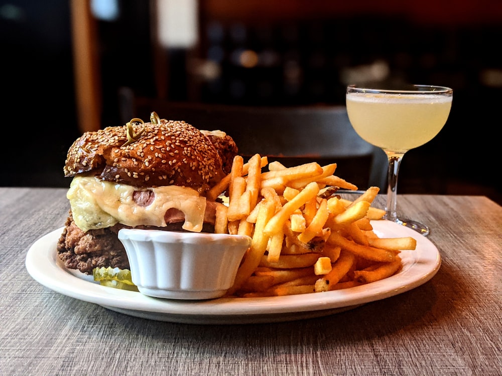 fries and burger on white ceramic plate