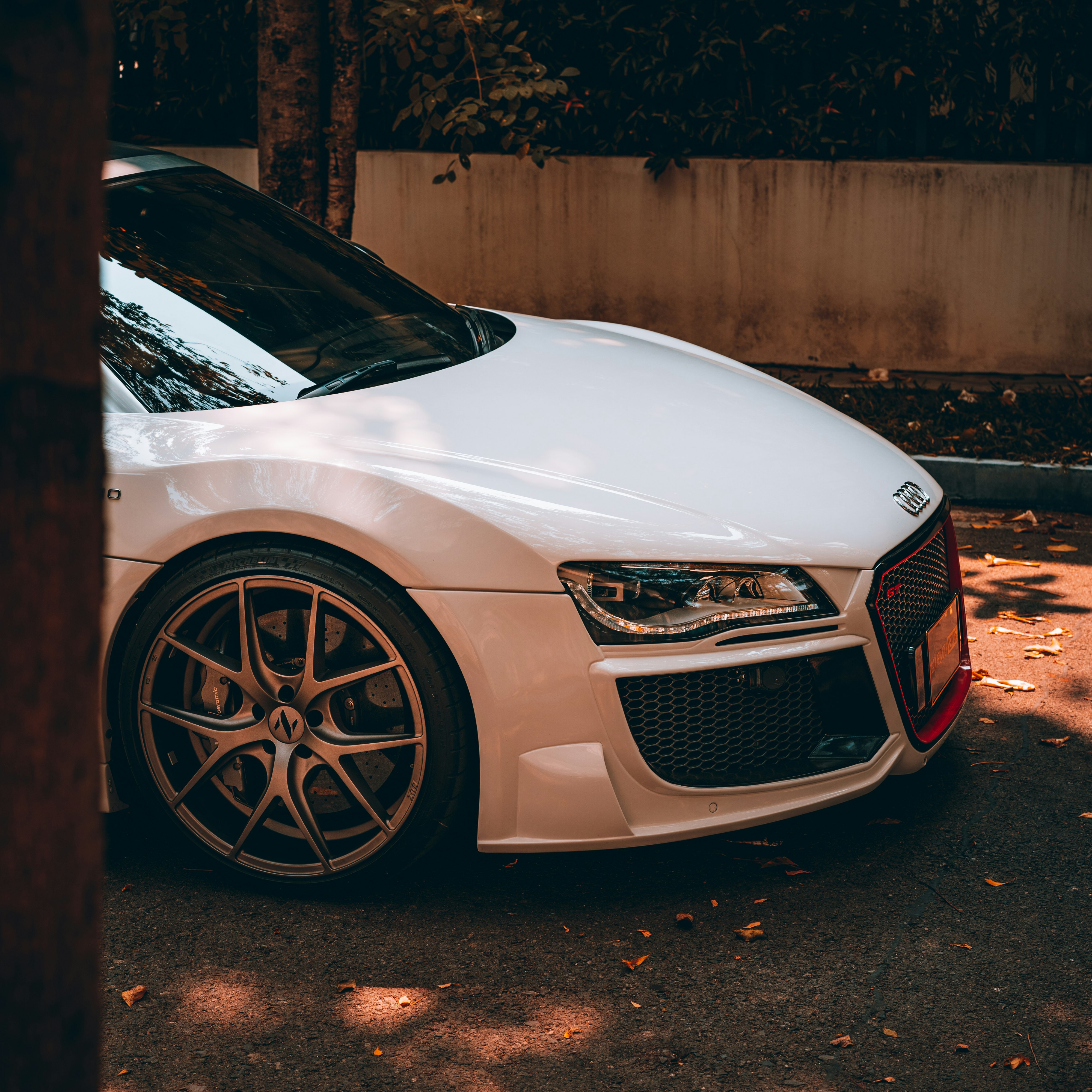 white audi r 8 parked on gray concrete pavement