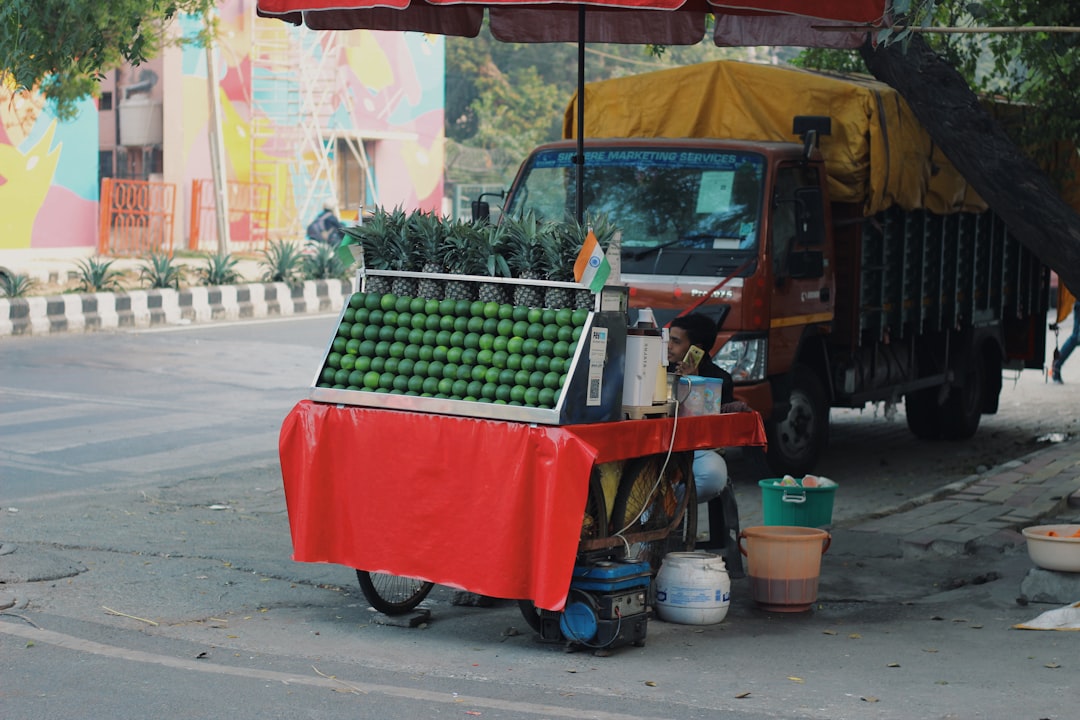 green and red plastic crate on red plastic cart