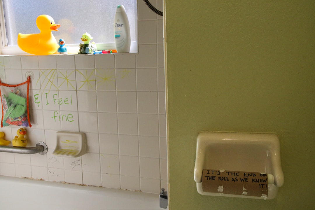 white plastic bottle on white ceramic wall mounted rack