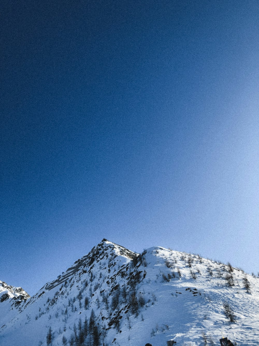 snow covered mountain under blue sky during daytime