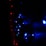 A string of bright blue LED lights arranged in a pattern, with smaller red lights forming a line to the left. The scene is dark, emphasizing the vivid glow of the lights against the shadowy background.