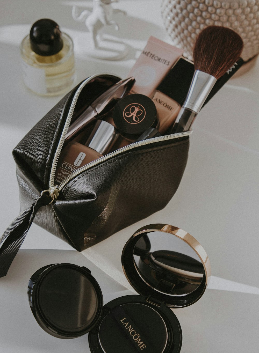 black leather bag with makeup brushes and makeup brushes