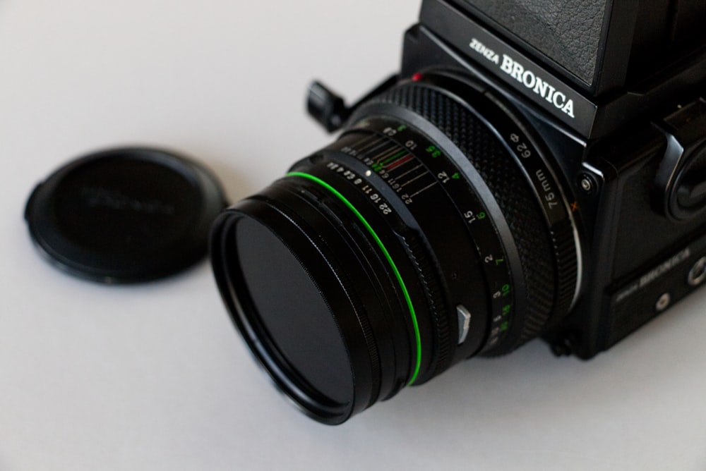 black nikon dslr camera on white table