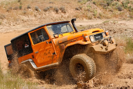 orange suv on brown sand during daytime in Tabriz Iran