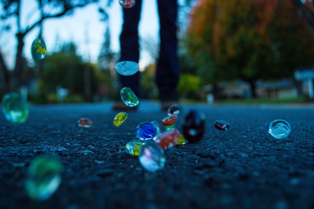 water droplets on black asphalt road during daytime