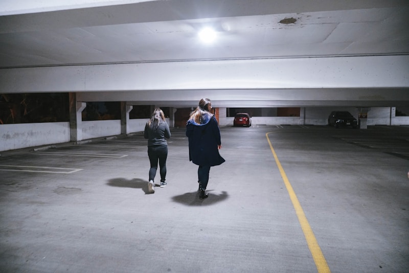 3 women standing on gray concrete floor