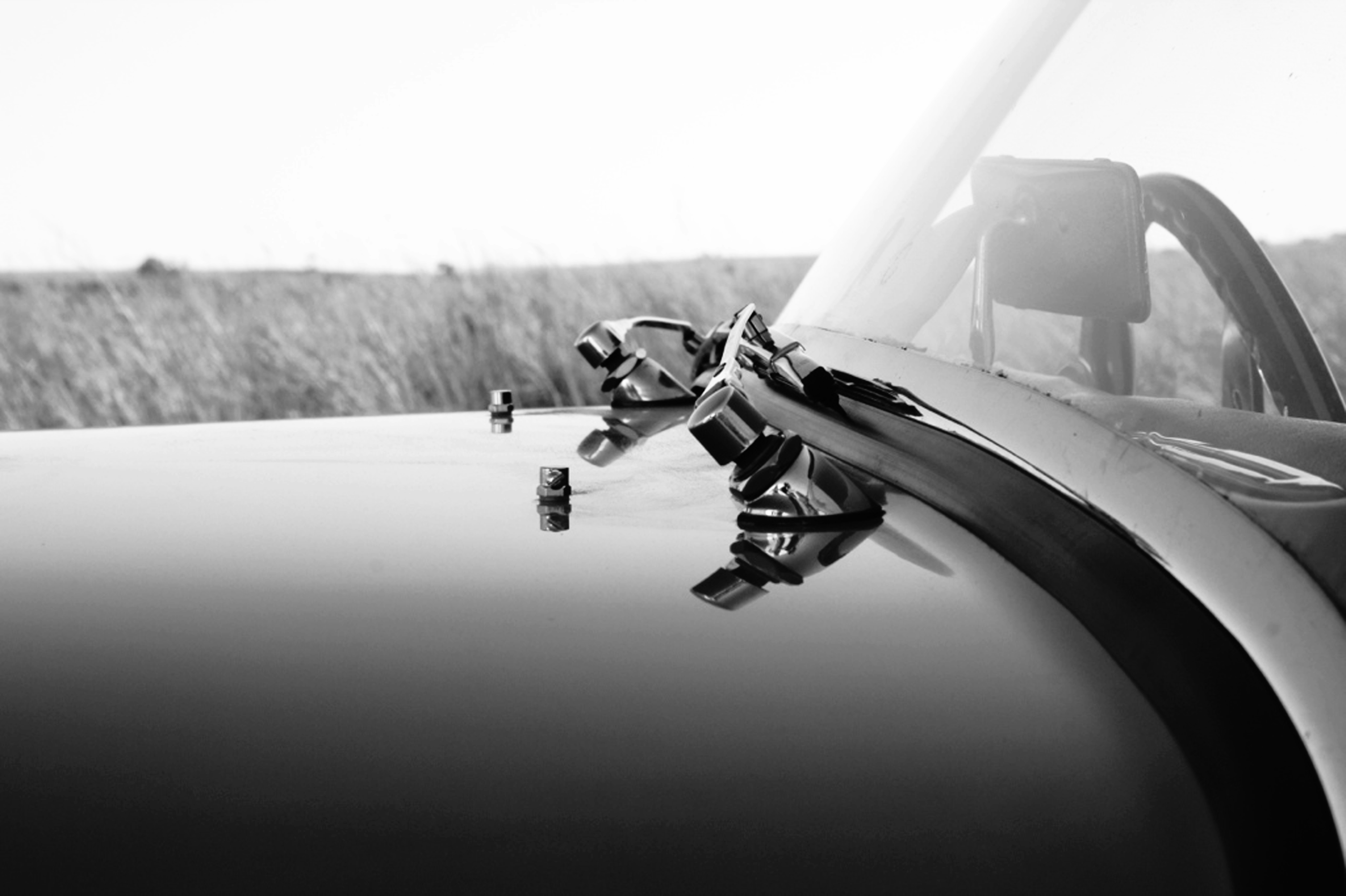 grayscale photo of man riding motorcycle
