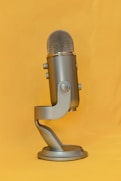 gray microphone on yellow textile