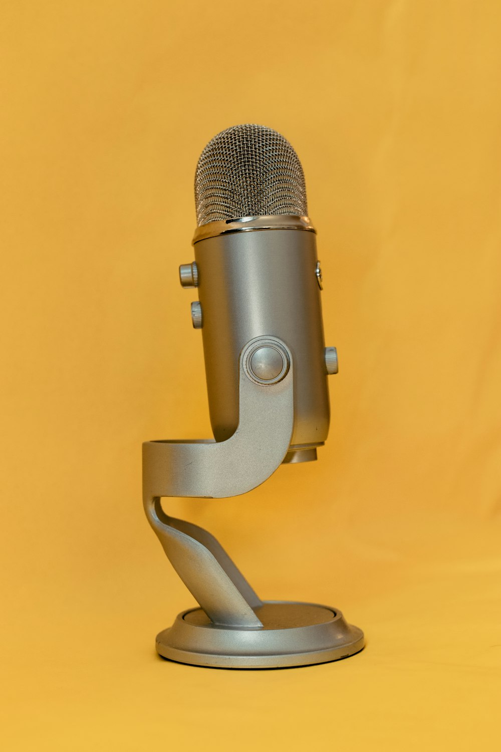 gray microphone on yellow textile
