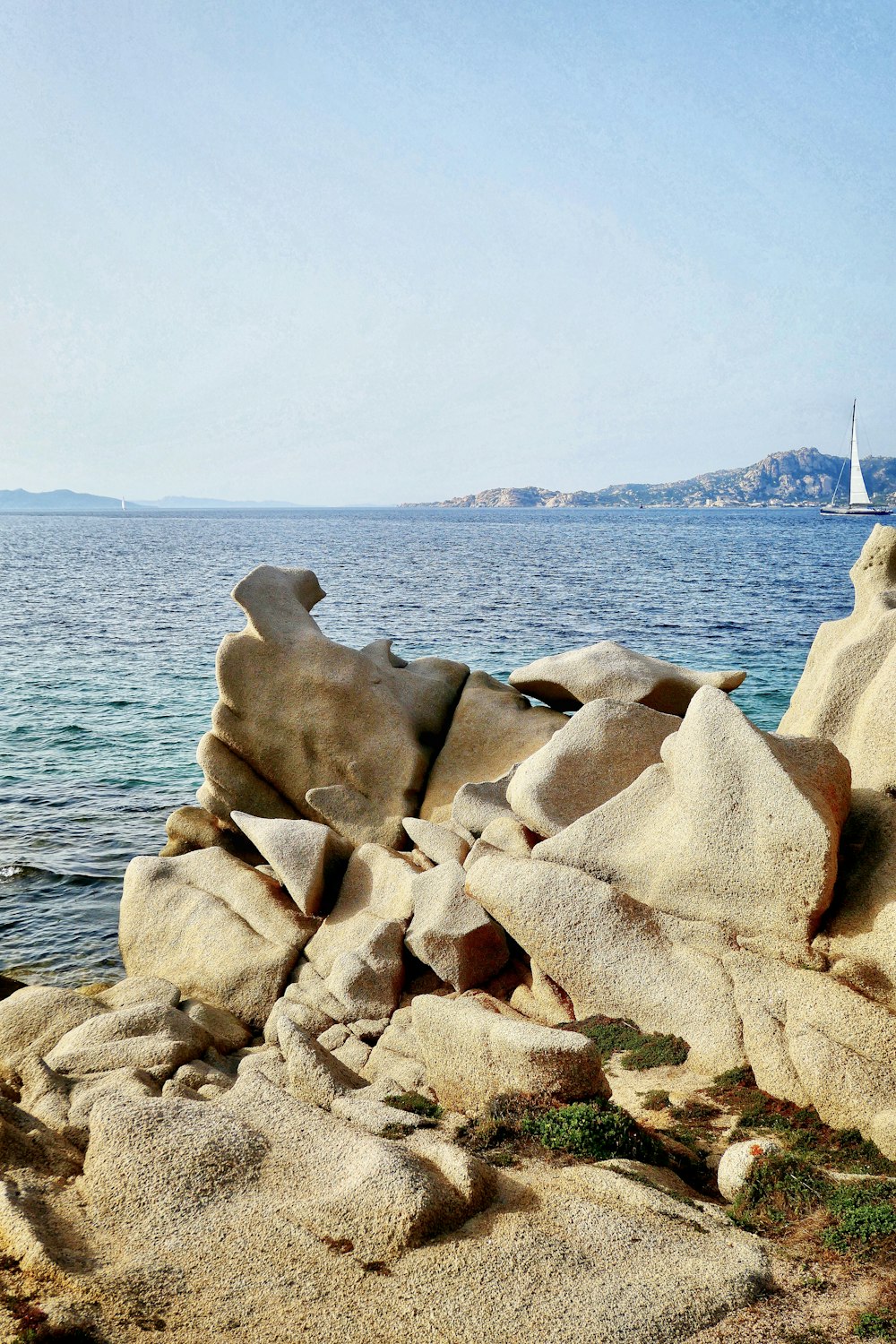 brown rock formation near body of water during daytime