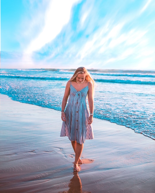 woman in white and black stripe dress standing on beach during daytime in Surfers Paradise Australia