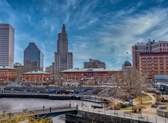 city skyline under blue sky and white clouds during daytime