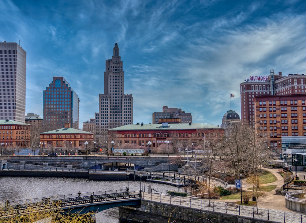 city skyline under blue sky and white clouds during daytime