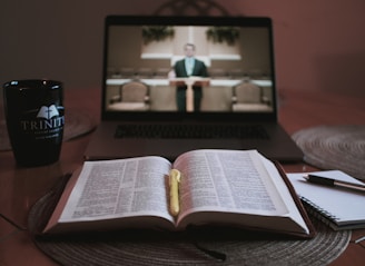 opened book on brown wooden table