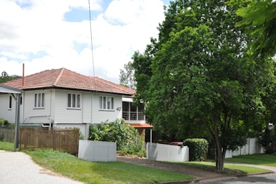 Cozy suburban house with a small garden and white fence.