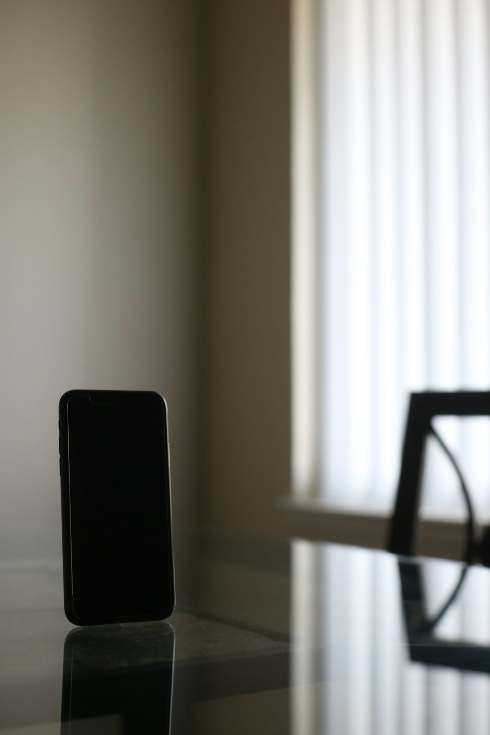 black smartphone on brown wooden table