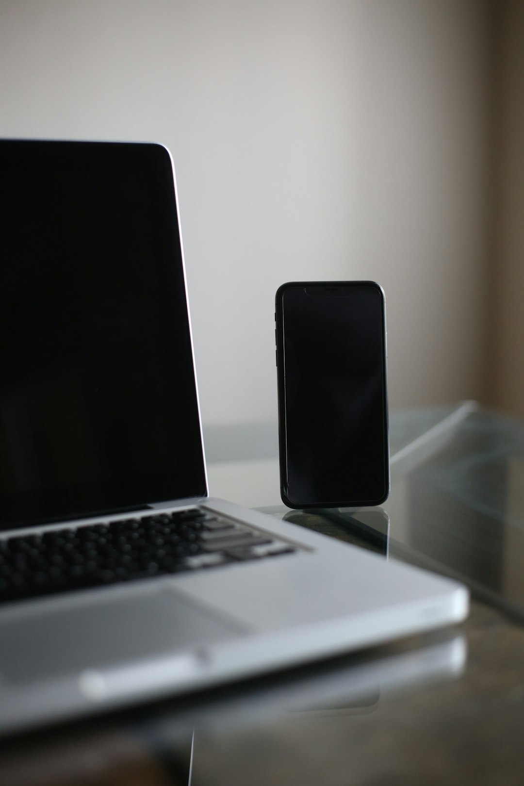 black smartphone on macbook pro