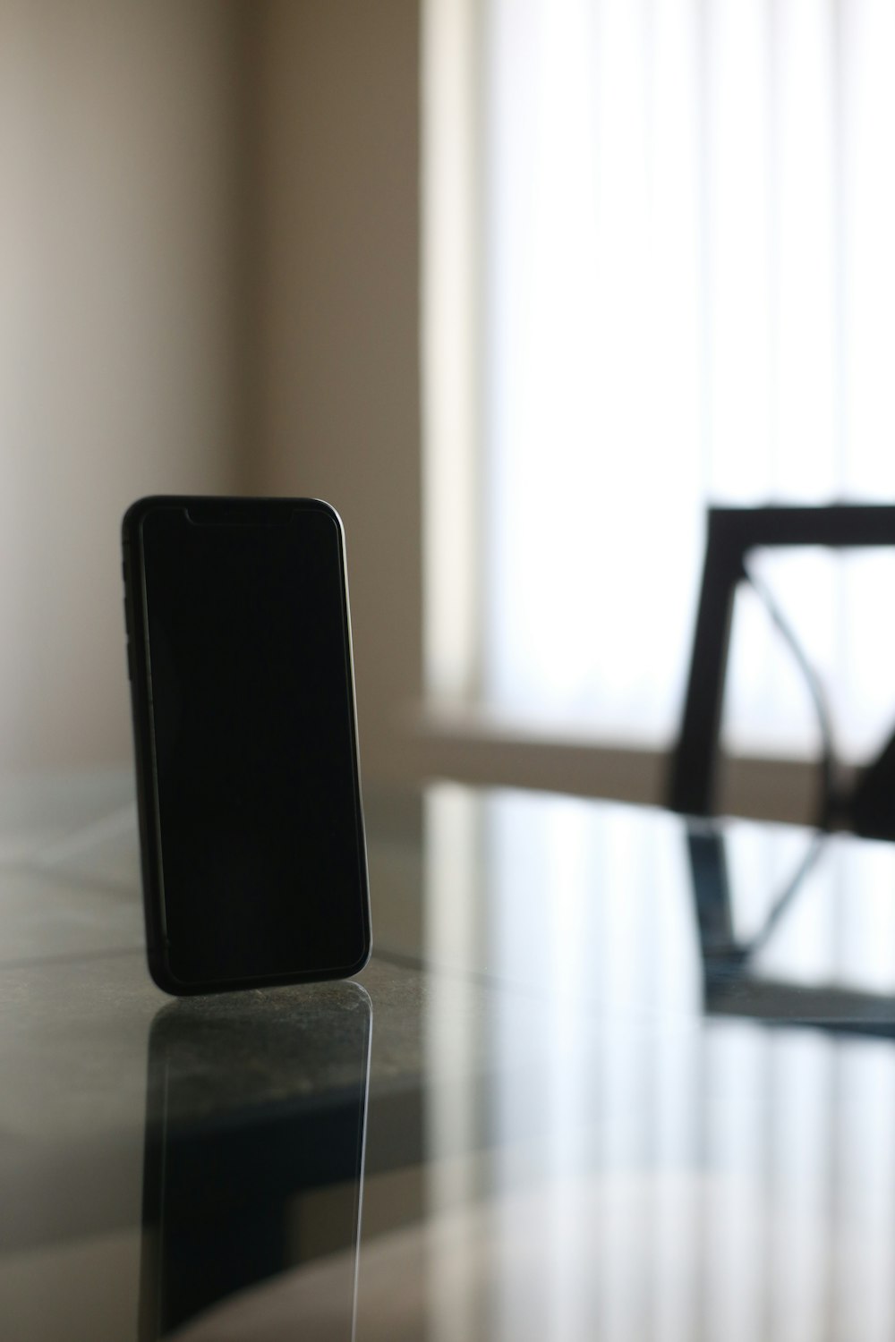 black smartphone on brown wooden table