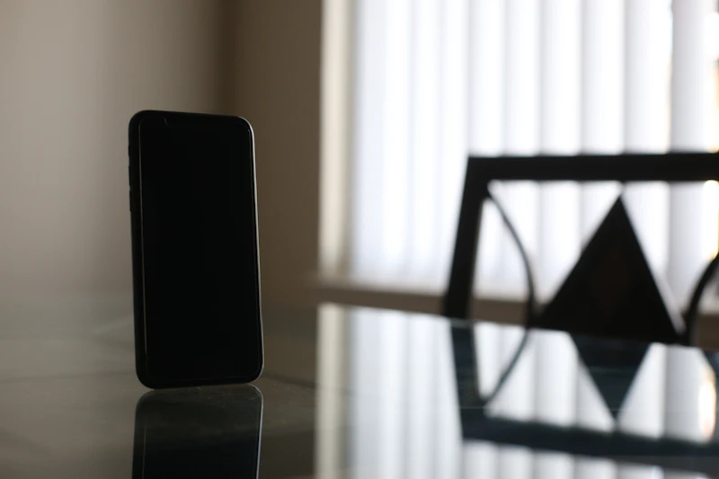 Smartphone resting on a wooden table, representing missed calls from customers